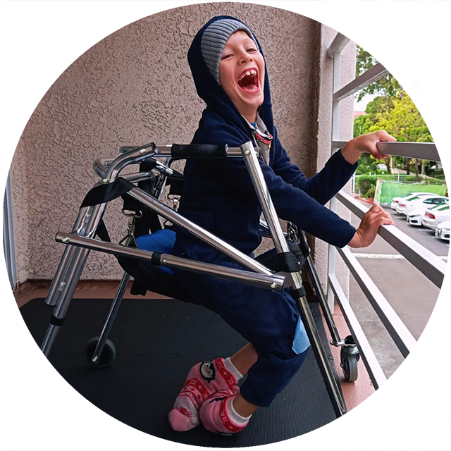 David smiling while using his walker